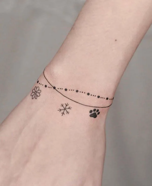 Cute small symbols on the wrist by @tattooer_ian