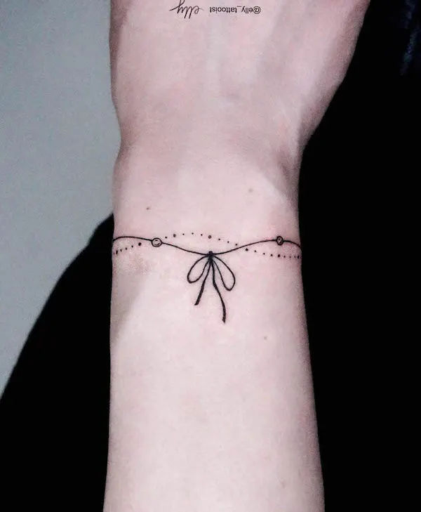 Ribbon bracelet tattoo by @elly_tattooist