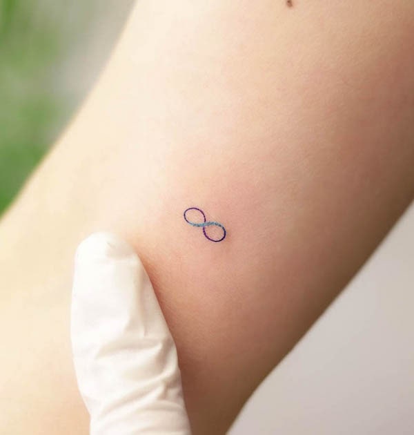 Small colored infinity tattoo by @wittybutton_tattoo