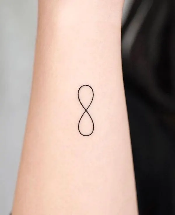 Small infinity side wrist tattoo by @simya_tattoo