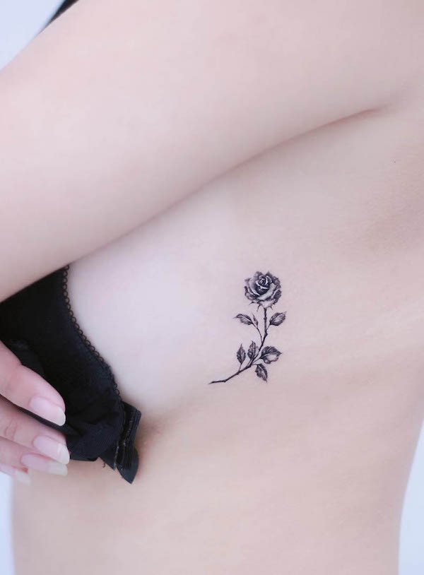 Microrealistic rose tattoo on the side boob