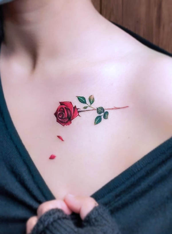 Small rose and petals collarbone tattoo by @black_opal_ink