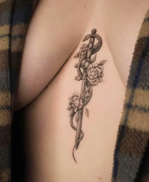 Snake and sword between the boob tattoo by @exp.haus