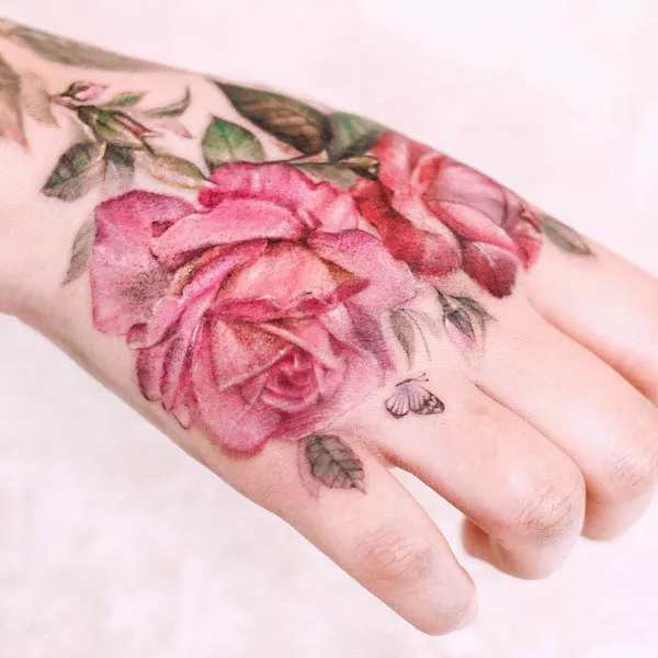 Stunning pink rose hand tattoo by @vandal_tattoo