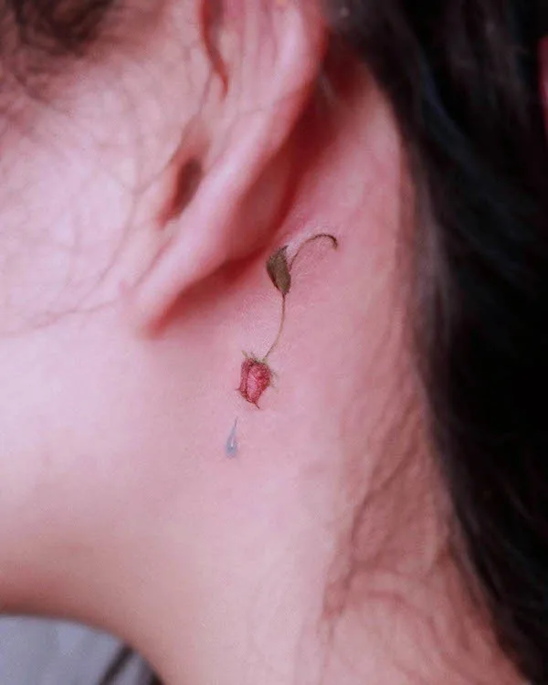 Tiny behind-the-ear rose tattoo by @renuue_ink