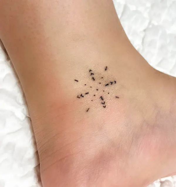 Tiny simplified mandala ankle tattoo by @mindletattoo