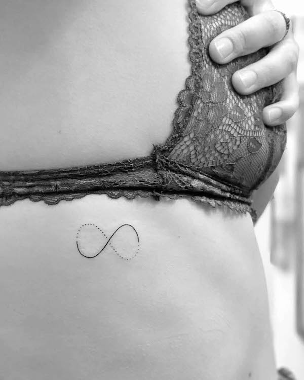 Unique infinity rib tattoo by @stephen_doyle_tattoo