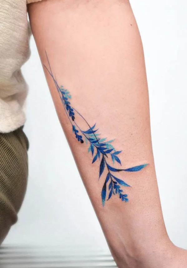 Blue leaves forearm tattoo by @eden_tattoo_