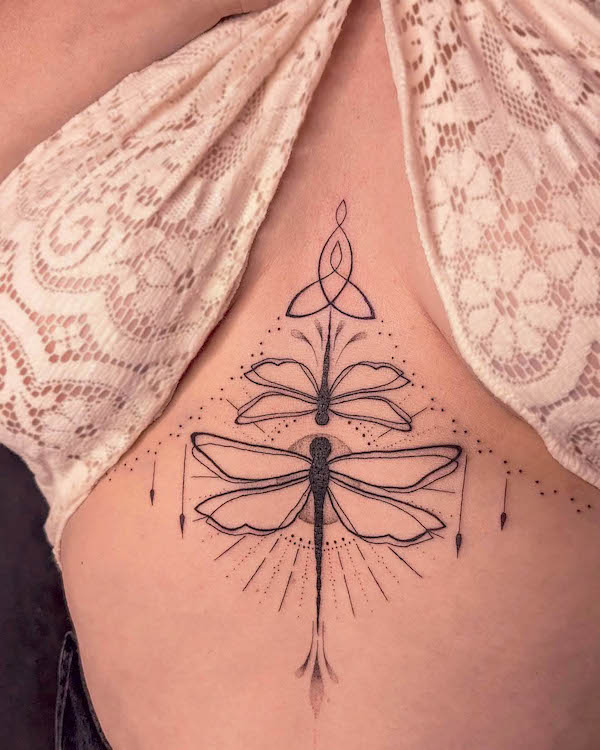 Dragonfly ornamental tattoo between the boobs by @bibi.lea_.tattoo