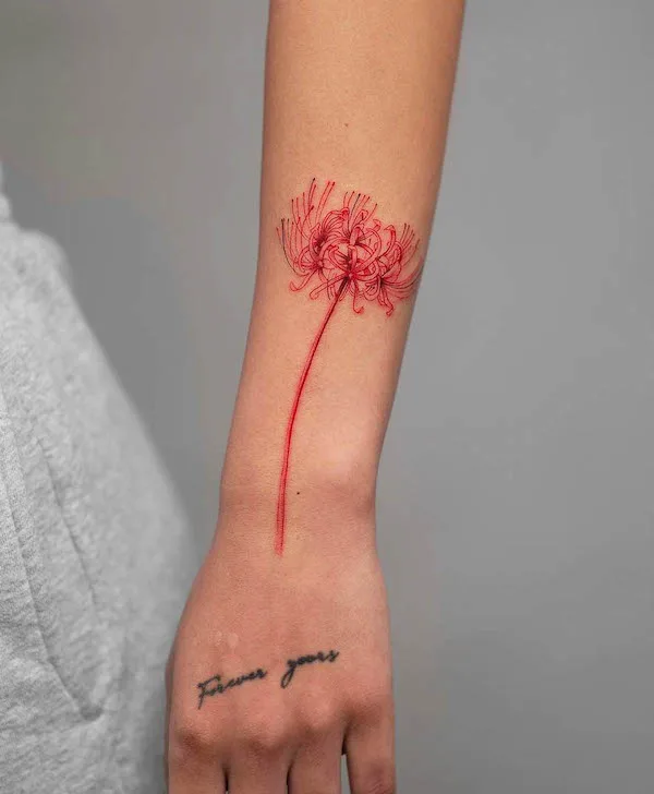 Elegant red spider lily forearm tattoo by @tatu_panda