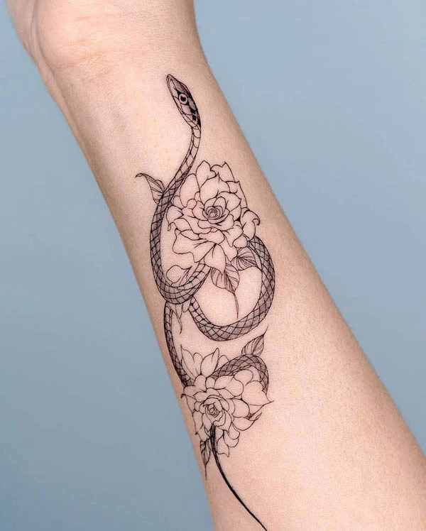 Floral snake forearm tattoo for women by @bium_tattoo