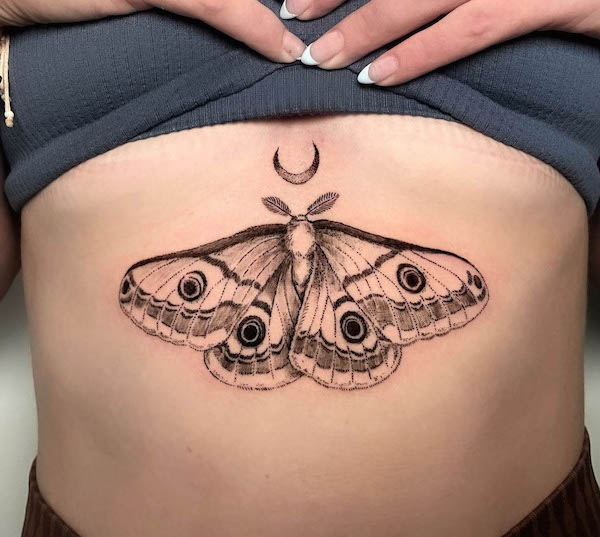 Moth and moon underboob tattoo by @jarhn_tattoos