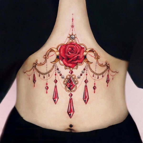 Rose and jewelry underboob tattoo by @yeriel_tattoo
