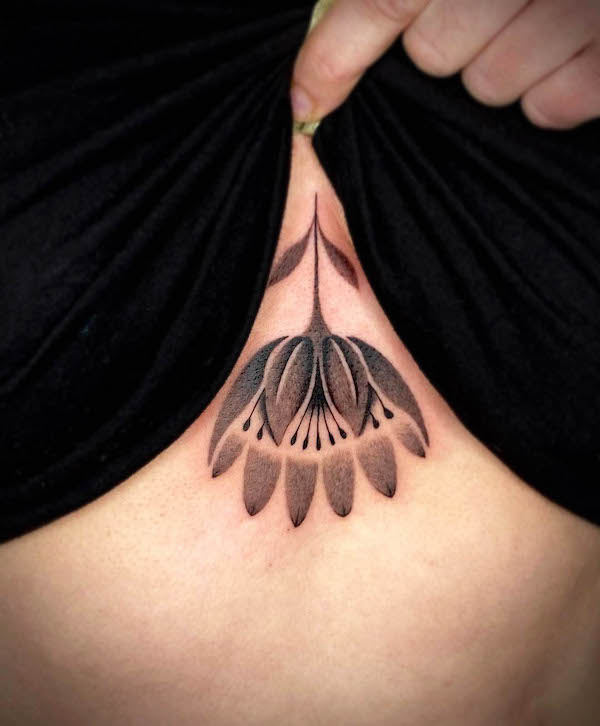 Black and grey reversing flower tattoo by @entala_tattoo
