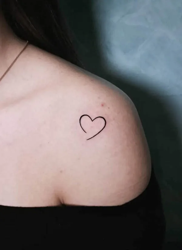 Small outline heart shoulder tattoo by @iva.kostova