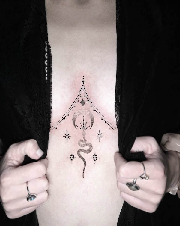 Small snake underboob tattoo with ornaments by @vivi_b_tattoo
