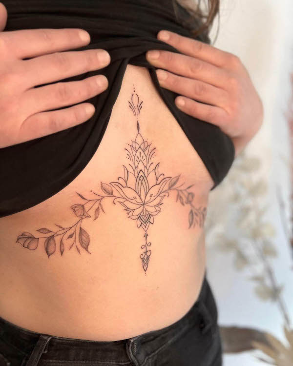 Symbolic lotus botanical underboob tattoo by @michaelafoordentattoo