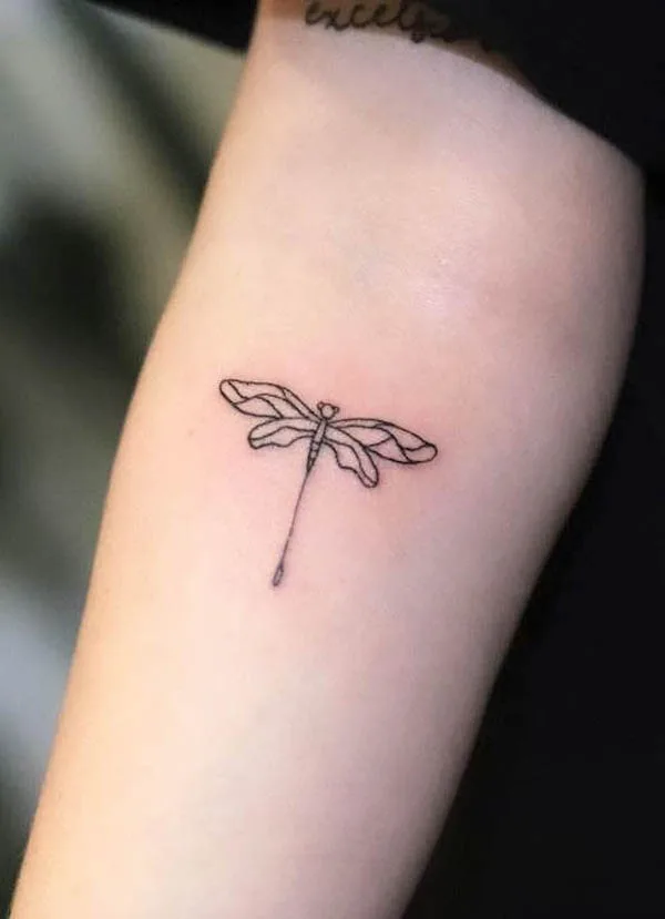 Hand poked dragonfly tattoo on the wrist