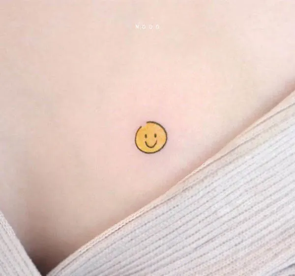 Tiny smiley face chest tattoo by @dettolphin