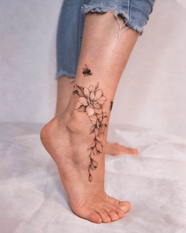 Bee and flowers foot tattoo by @polar.tattooing