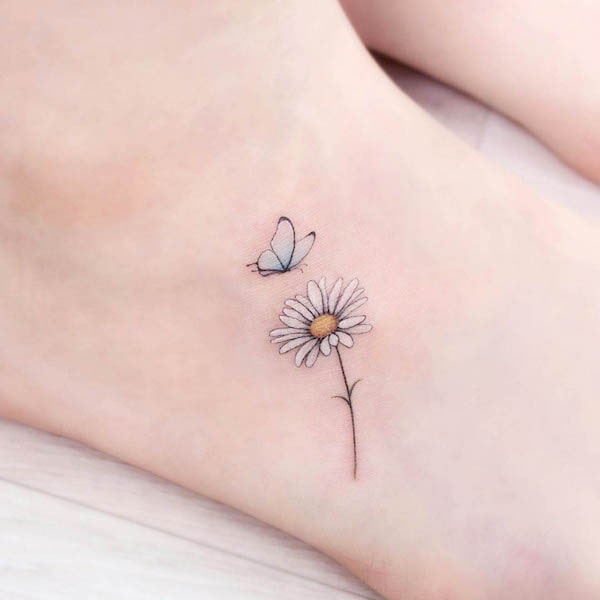 Butterfly and daisy foot tattoo by @tattooist_greem