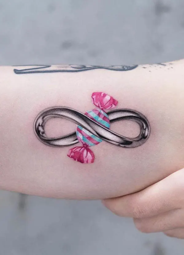 Candy and infinity tattoo by @inkflow_akiwong
