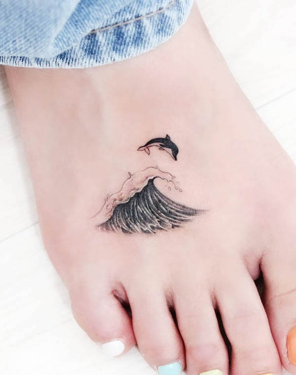 Dolphin and wave foot tattoo by @tattooist_greem