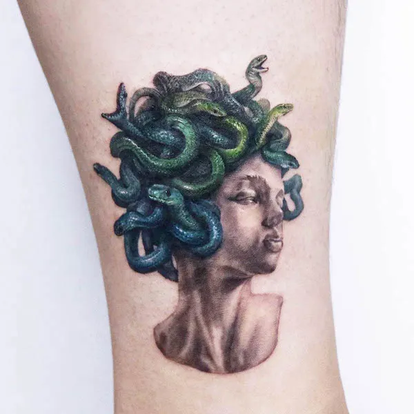 Emerald Medusa sculpture tattoo by @ink.traveler