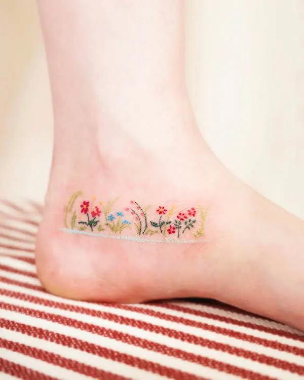 Flower garden ankle tattoo by @yeguclub