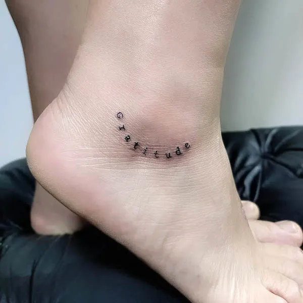 Gratitude one word ankle tattoo by @barbaraguerrart