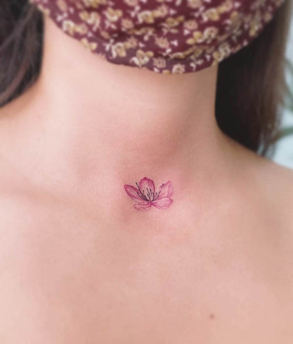 Small cherry blossom neck tattoo by @eva_tattooist