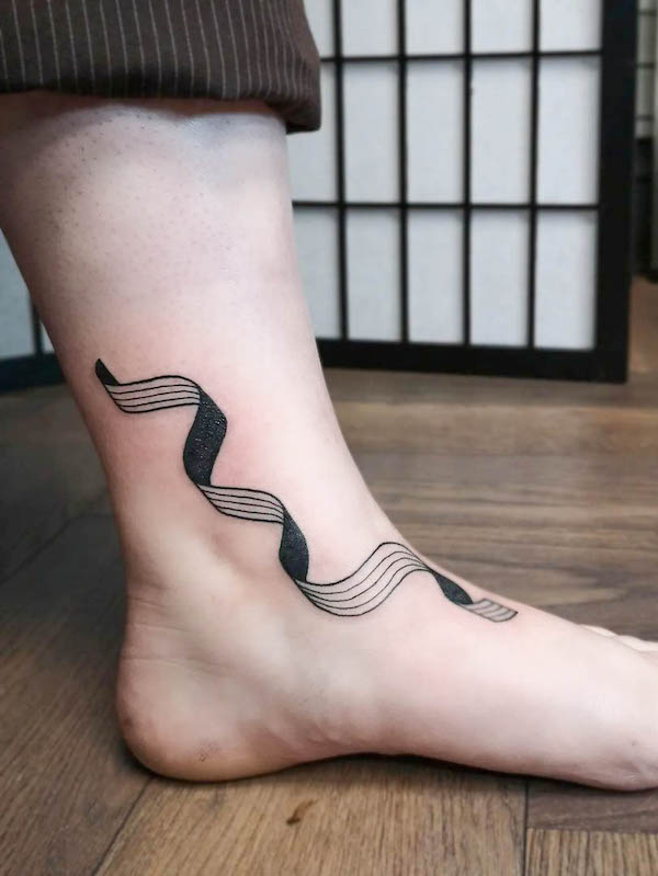 Squiggle foot tattoo by @eviesttt