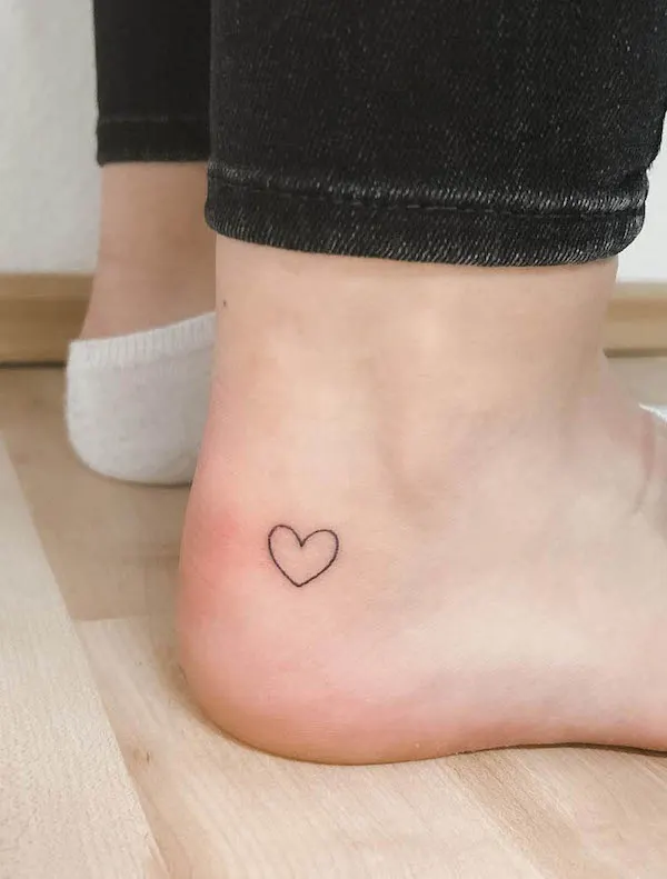 Tiny heart foot tattoo by @pureandfine.tattoo