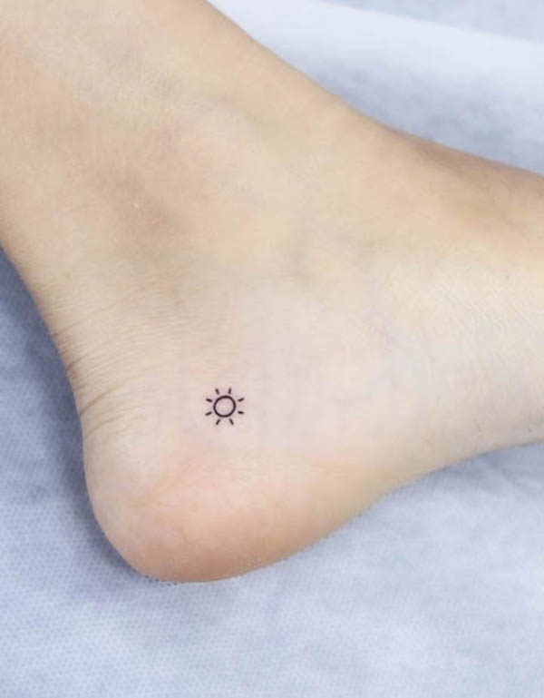 Tiny sun ankle tattoo by @wittybutton_tattoo
