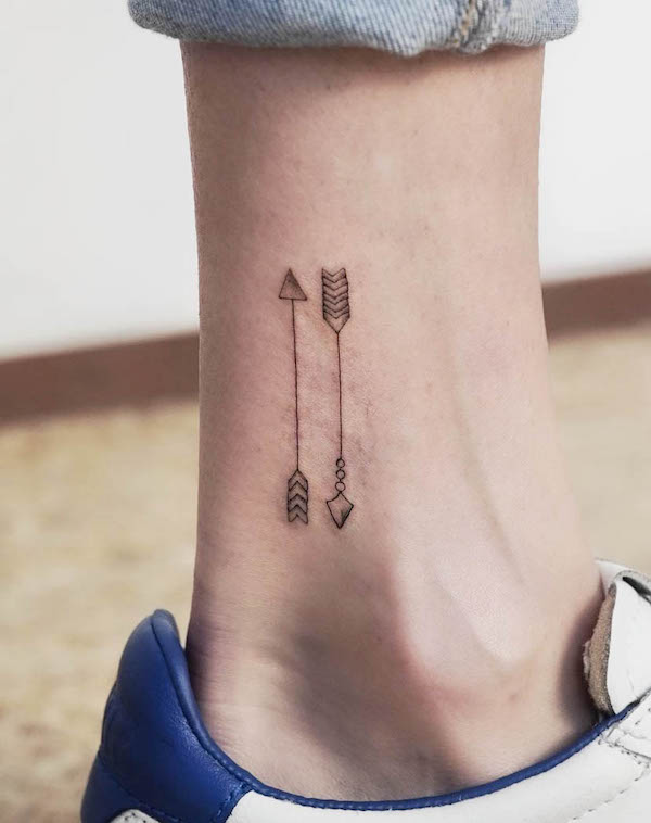 Double arrows fine line tattoo by @pauliparker.ink