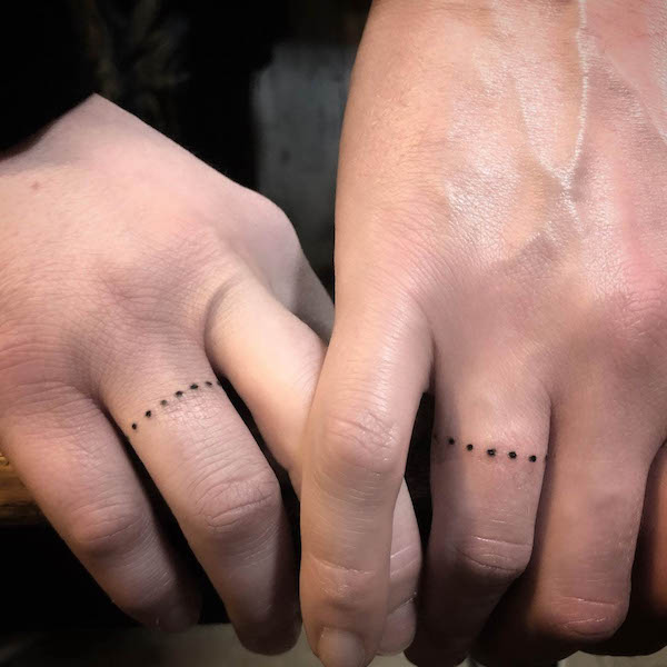 Dots around the finger by @ihudatattoo