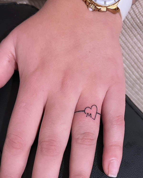 Heart and initial wedding ring tattoo by @speediitattoo