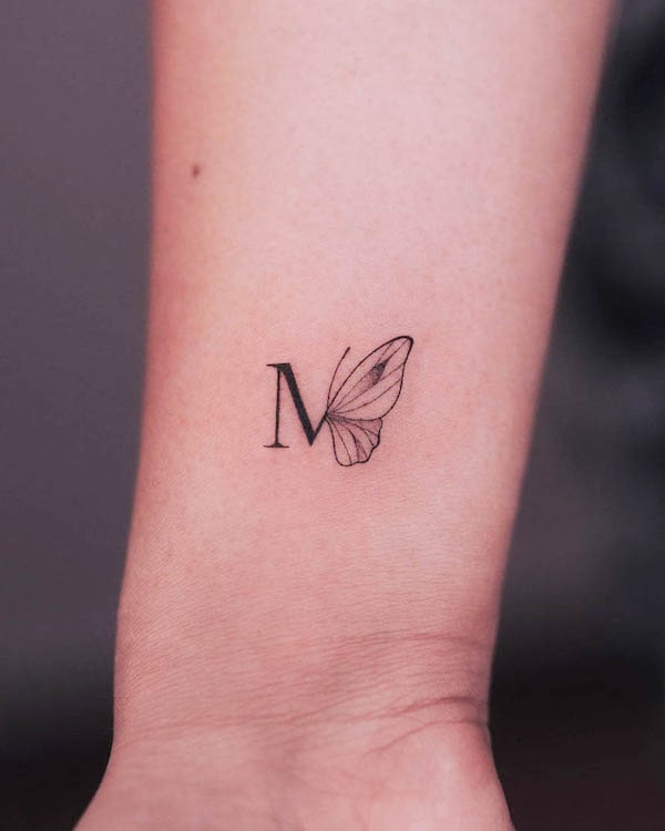 Initial and butterfly fine line tattoo by @cha.tattoo