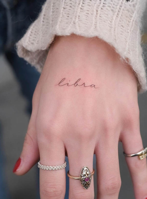Libra fine line script tattoo by @stefano__mazza