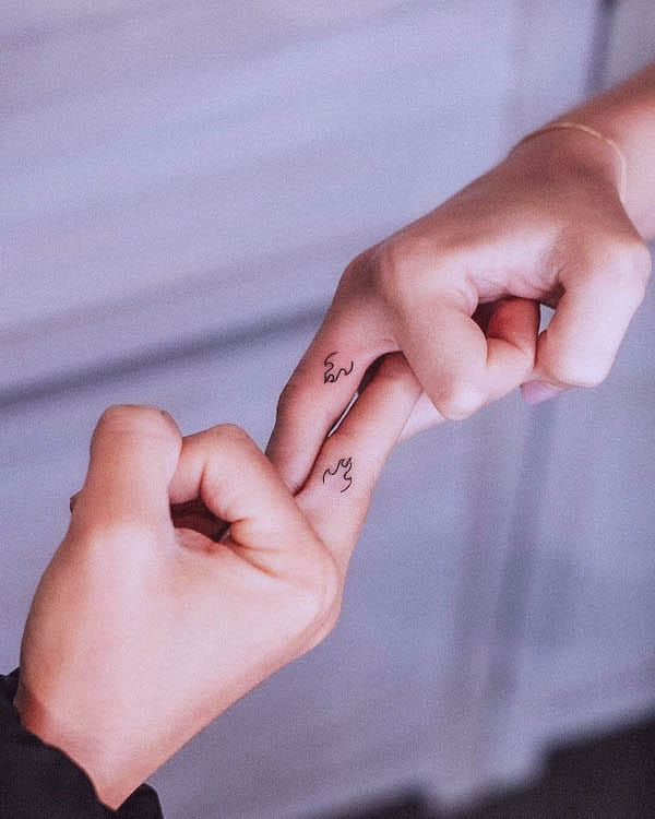 Matching fire finger tattoos by @tavi_tattoo