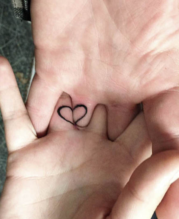 Matching heart wedding ring tattoos by @billybtattoos