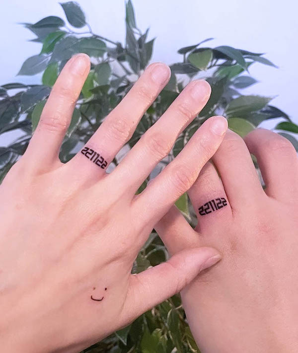 Matching number wedding ring tattoos by @hawol_tattoo