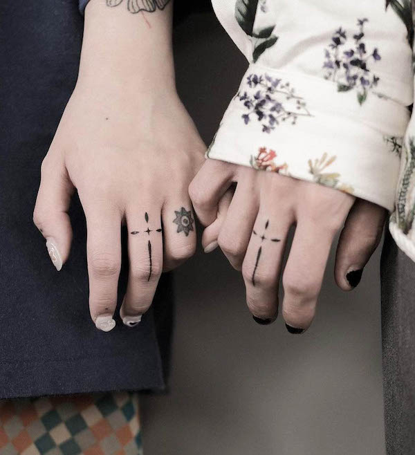 Matching cross ornamental finger tattoos by @krisauau