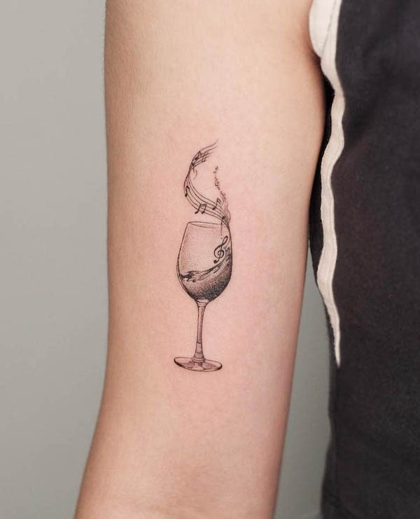 Music and wine glass fine line tattoo by @grayscale.tattoo