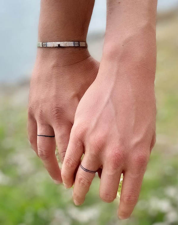 Simple line wedding ring tattoos by @joji.93
