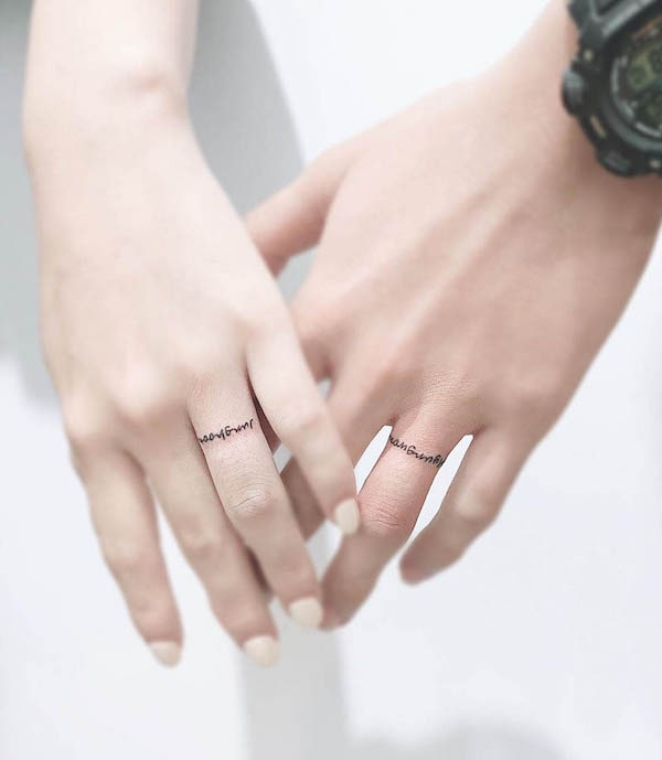 Small script wedding ring tattoos by @morae_tattoo