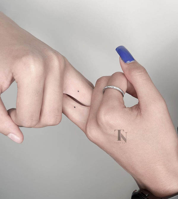 Tiny dot wedding ring tattoos by @nazanin.tntattoo