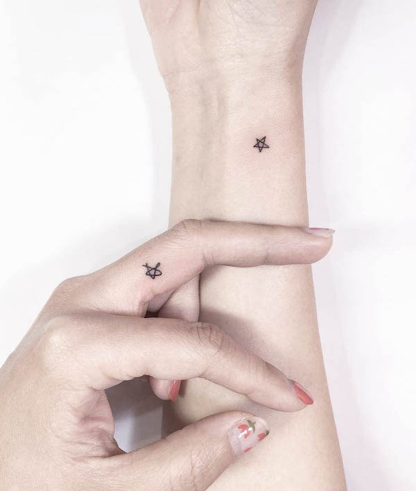 Small matching star tattoos by @playground_tat2