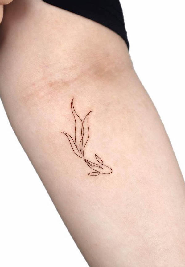 Small minimalistic koi fish tattoo by @gigi_tattooer