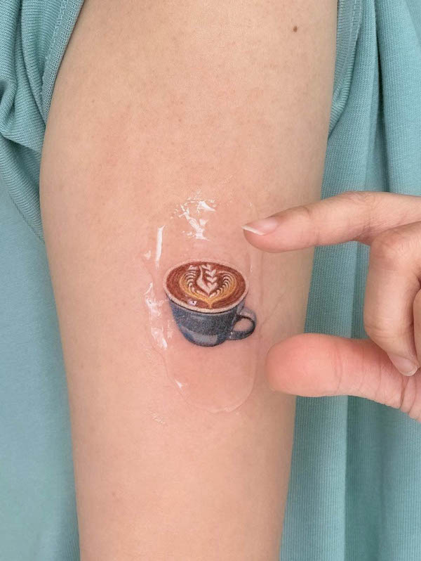 Tiny coffee cup tattoo by @dianaiitattoo